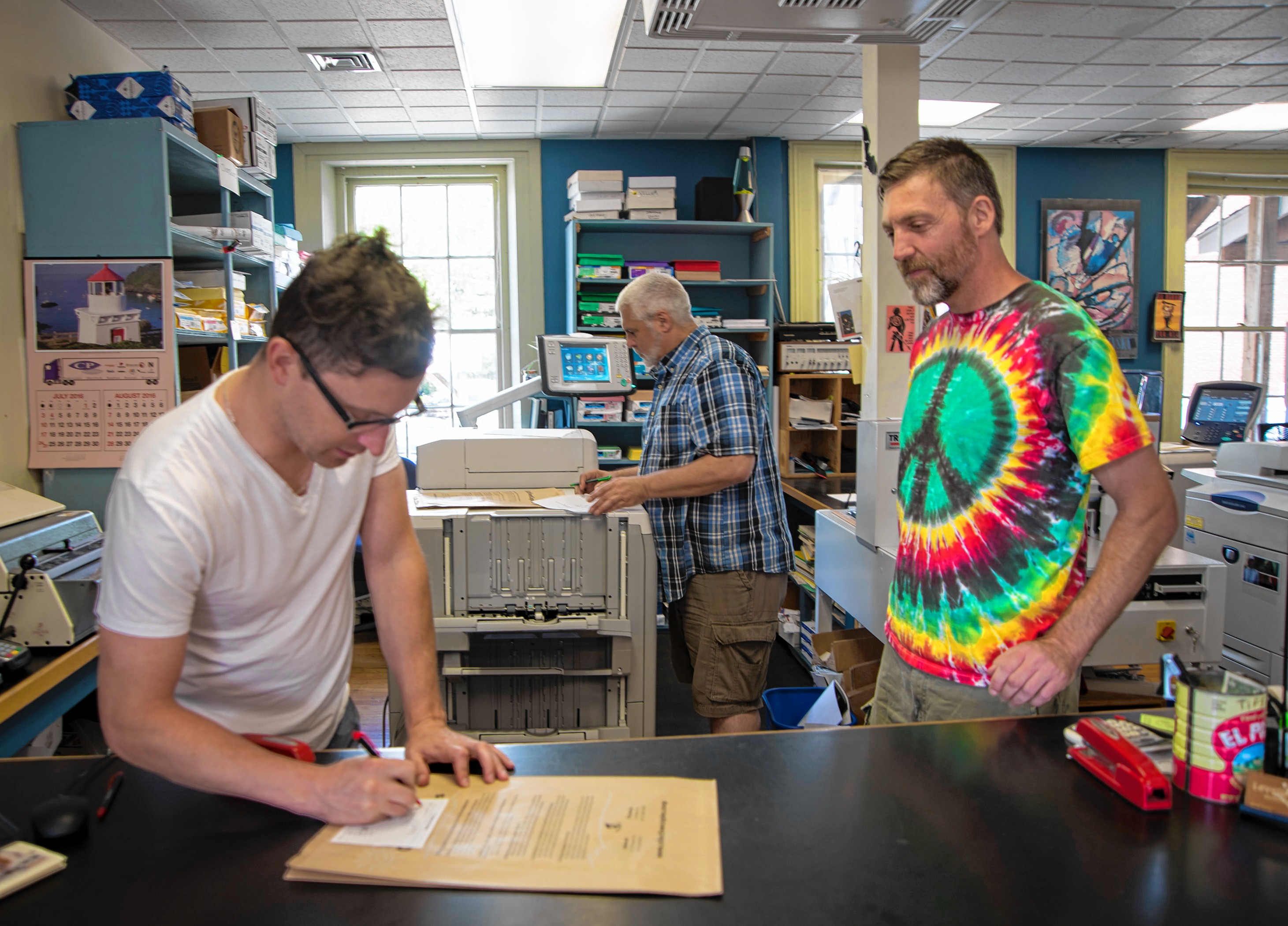 Collective Copies employees Adam Trott, left, Gregory Balsewicz, center, and Randy Zucco, right, inside their business at 93 Main in downtown Florence.